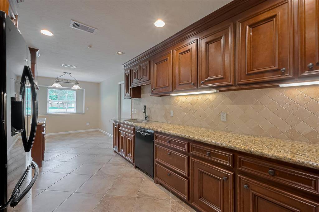 This kitchen has custom cabinets, granite countertops and so much storage.  The refrigerator is also included.