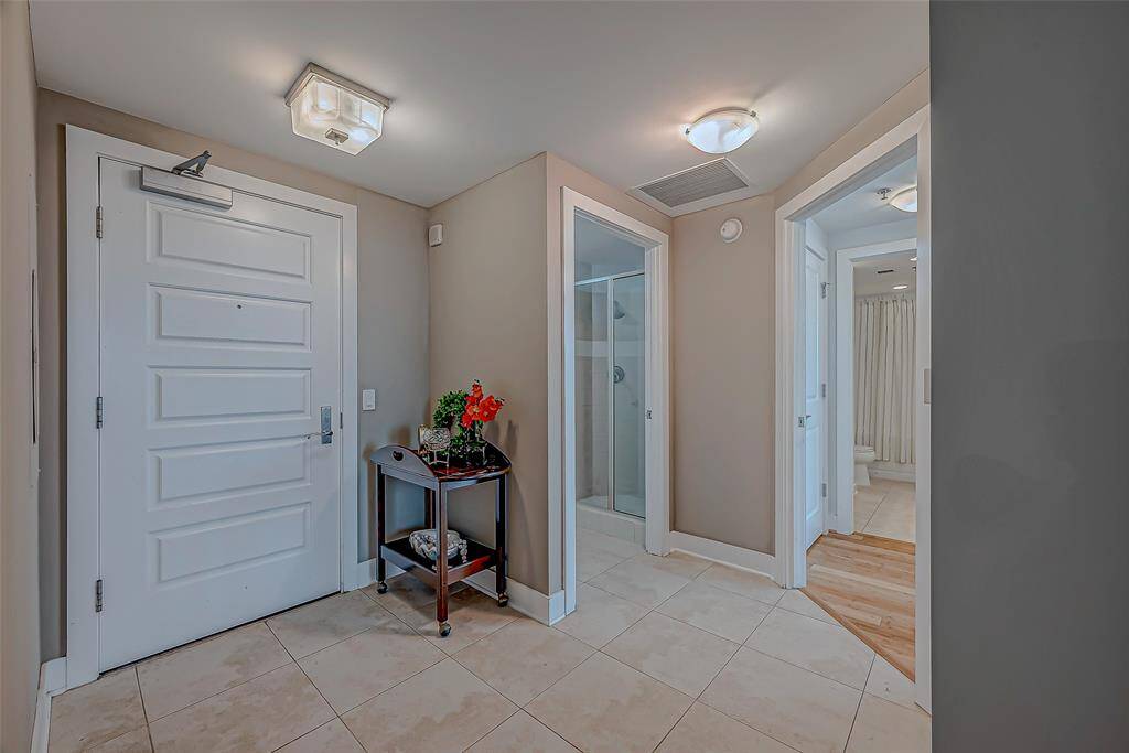 Welcoming entry with elegant custom tile and seamless bamboo flooring throughout.