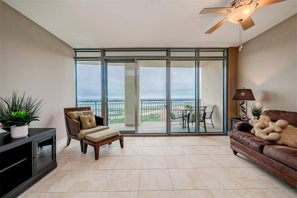Experience breathtaking floor-to-ceiling windows in the family room, offering uninterrupted views of the bay and the majestic sight of cruise ships gliding in and out of Galveston.