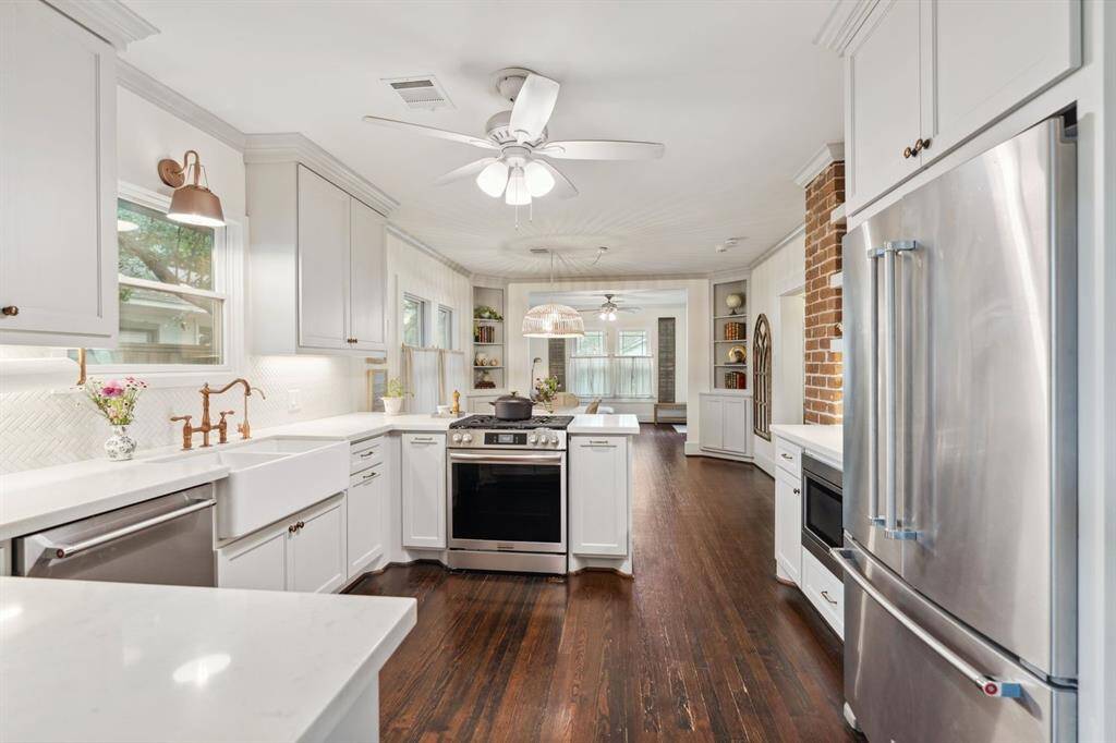 With stainless appliances, gas stove and convection oven, roomy walk-in pantry, quartz countertops, custom cabinets, and designer finishes, the kitchen has it all!