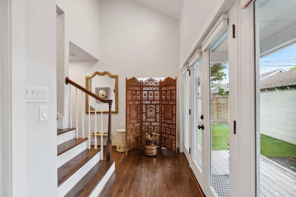 Double doors escort you to the luscious backyard.