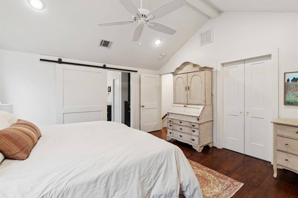 A striking, sliding barn door leads you into the primary bathroom and behind the double doors you will find a sizeable walk in closet.