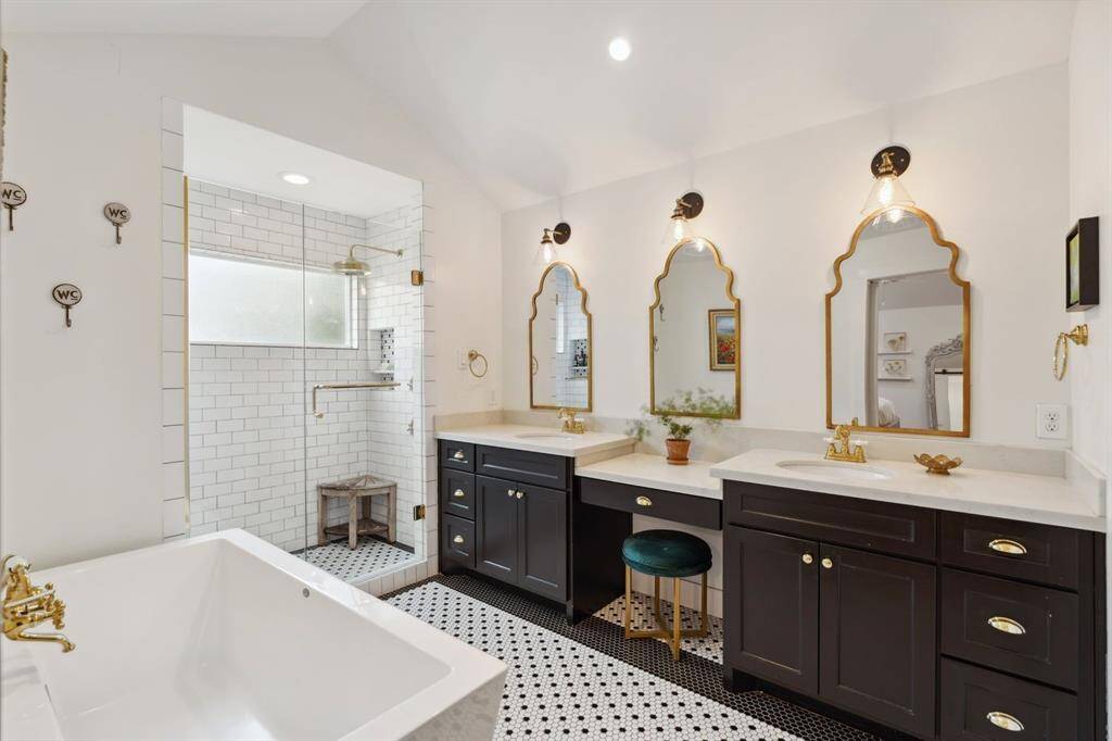 Penny tile flooring, polished brass fixtures and subway tile shower all tie in perfectly to create an exquisite space.