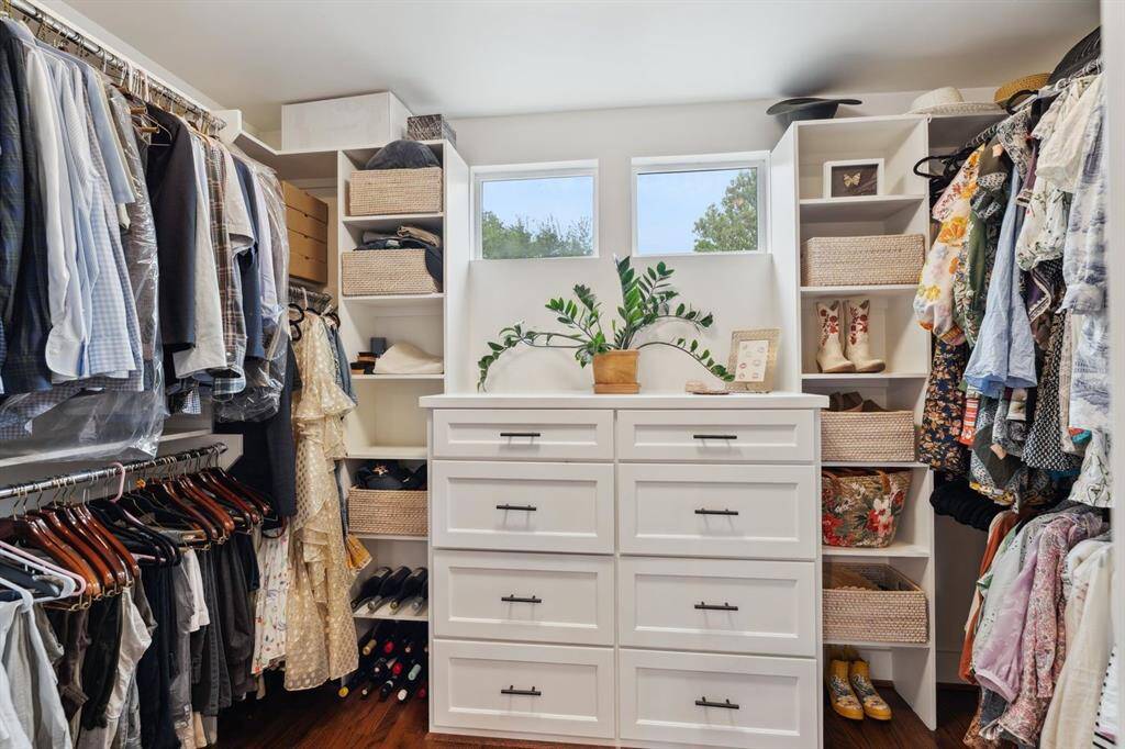 Custom walk-in closet with built-in shelving and drawers.