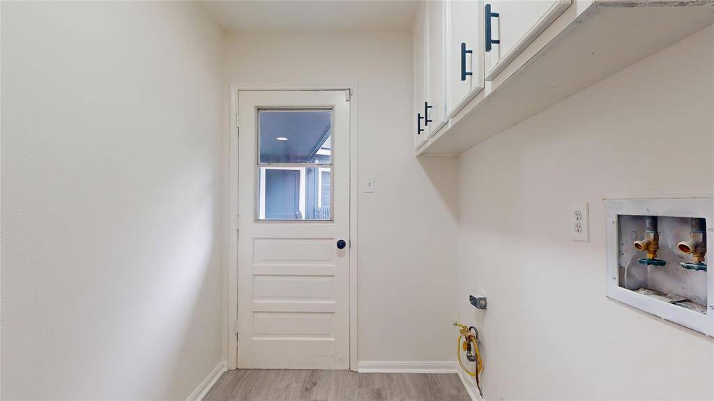 The garage connects with the back of the house via a breezeway - nice way to stay dry when stepping into your home! Notice all the storage in the laundry room!