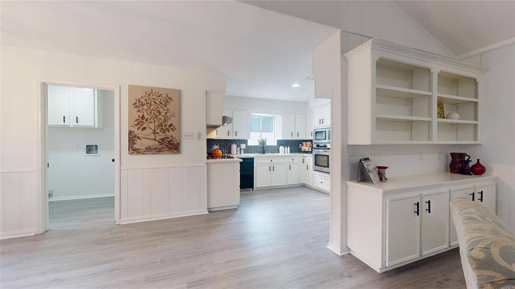 View of the kitchen and breakfast area (to the left of the picture) - you can also see part of the large laundry room; there is a half bath next to it!