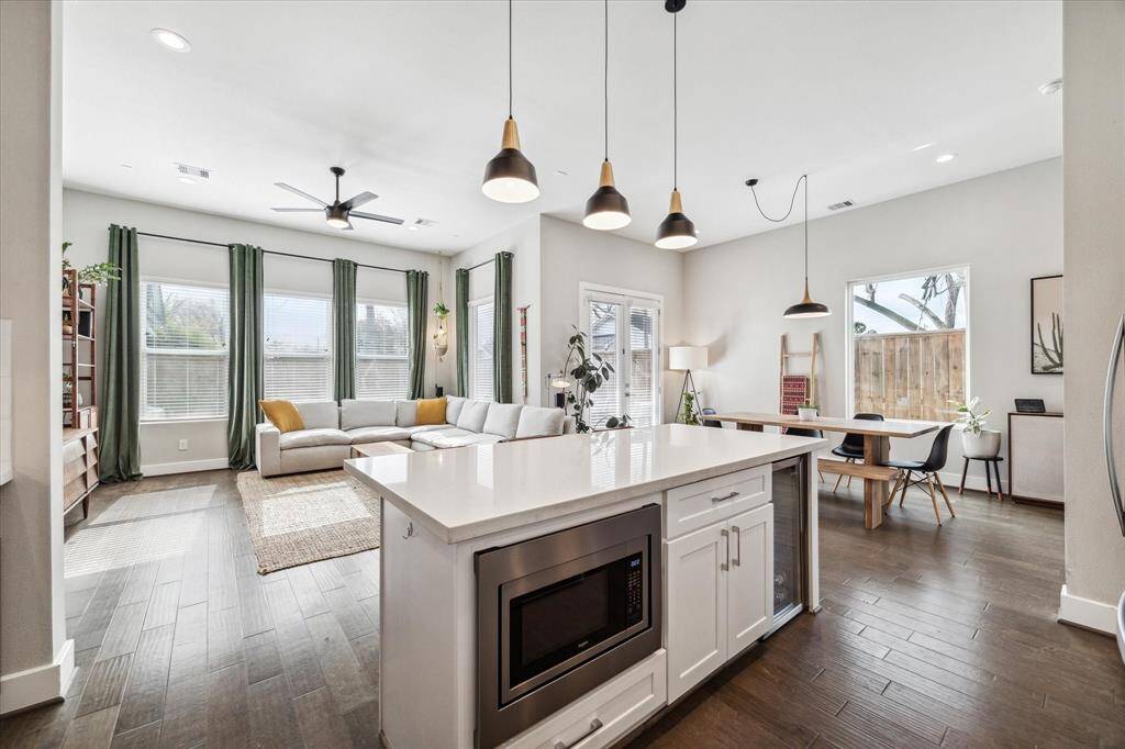 Oversized kitchen island with wine fridge and microwave discreetly tucked away to save on counter top space.