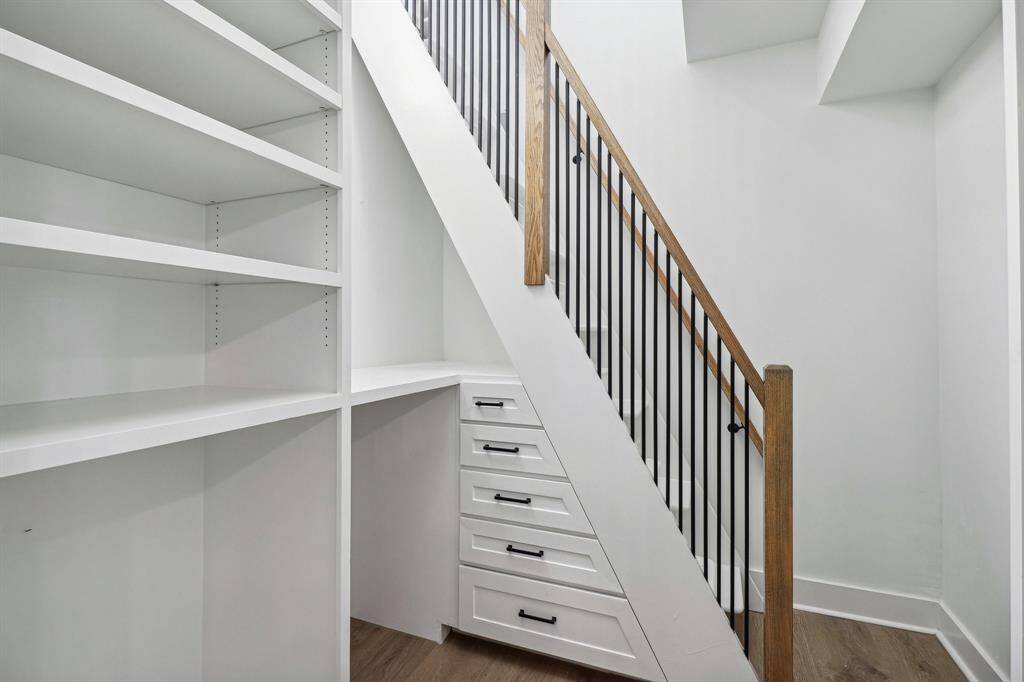 2 story primary closet with tons of built-ins ensuring organization and style