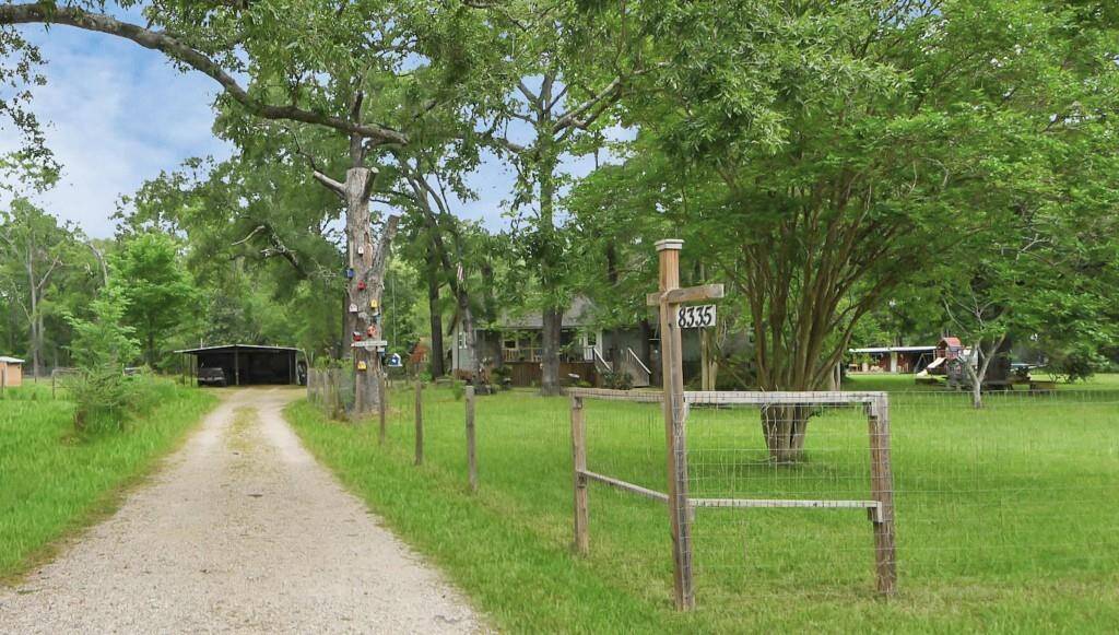 The driveway leading to the carport and an open picture of this beautiful property.