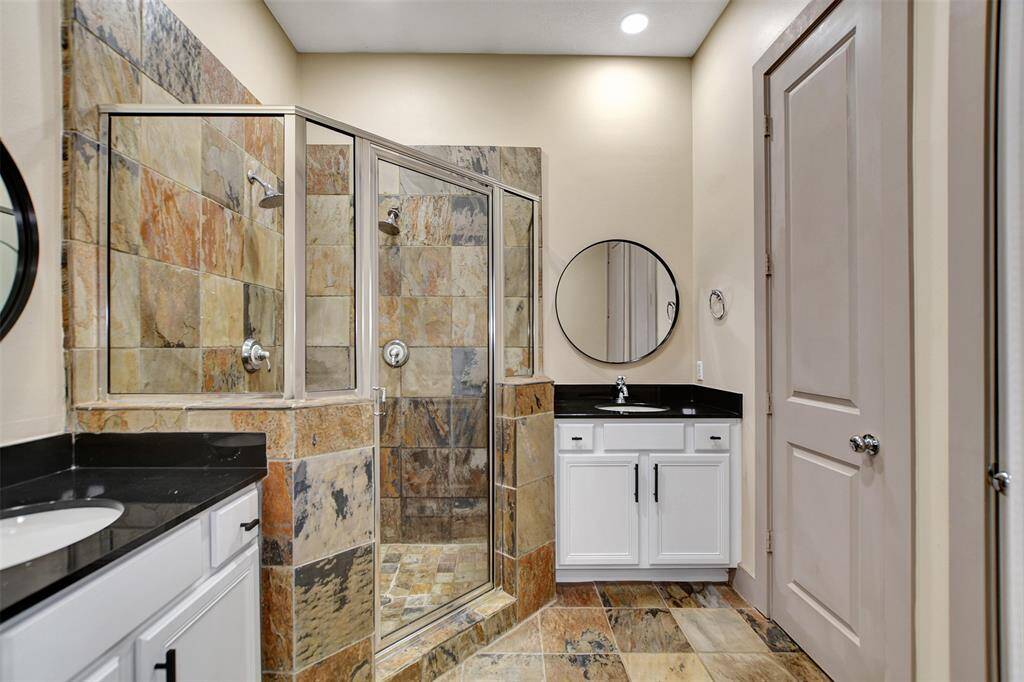 Large primary bathroom with his and her vanities and large shower.