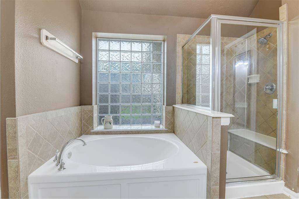Another view of the shower and soaking tub in the primary bathroom.