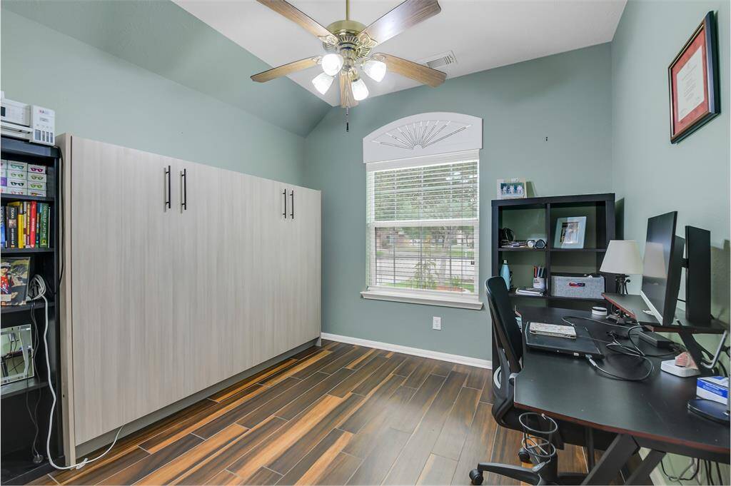 The third bedroom downstairs is currently being used as a second office.