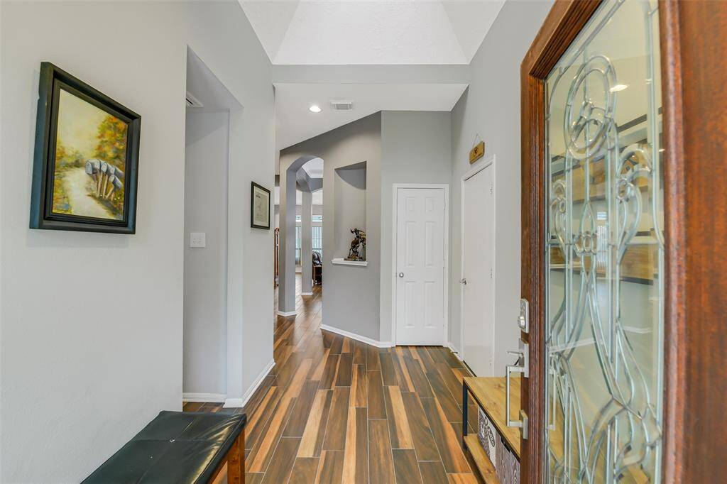 Stepping inside, you are welcomed by the bright and airy front entrance.  Wood-look ceramic tile extends throughout much of the home.