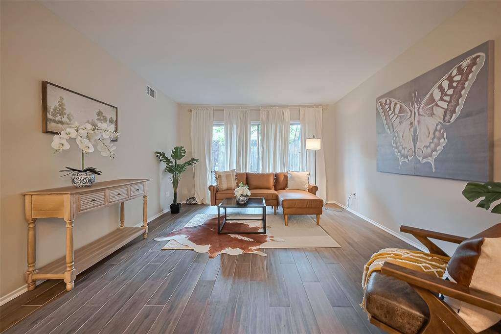 Step into the open-concept family room filled with natural light, featuring durable flooring and fresh, neutral paint that creates a bright and welcoming space.