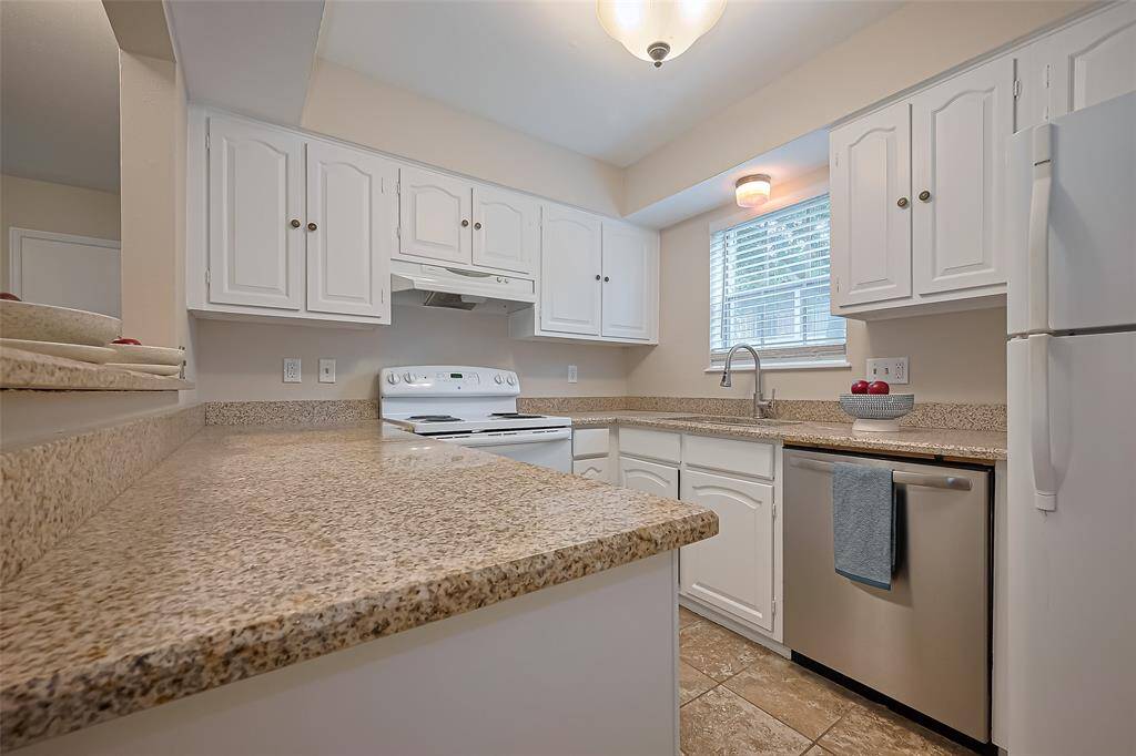 The kitchen features beautiful granite countertops and an abundance of cabinet space, making it as functional as it is stylish—perfect for cooking, storing, and entertaining with ease.