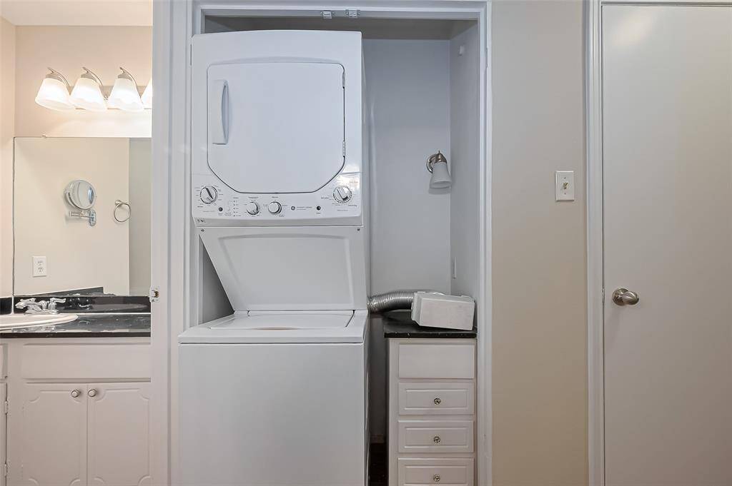 Conveniently located just off the bathroom is the laundry space featuring built-in drawers for added storage and organization.