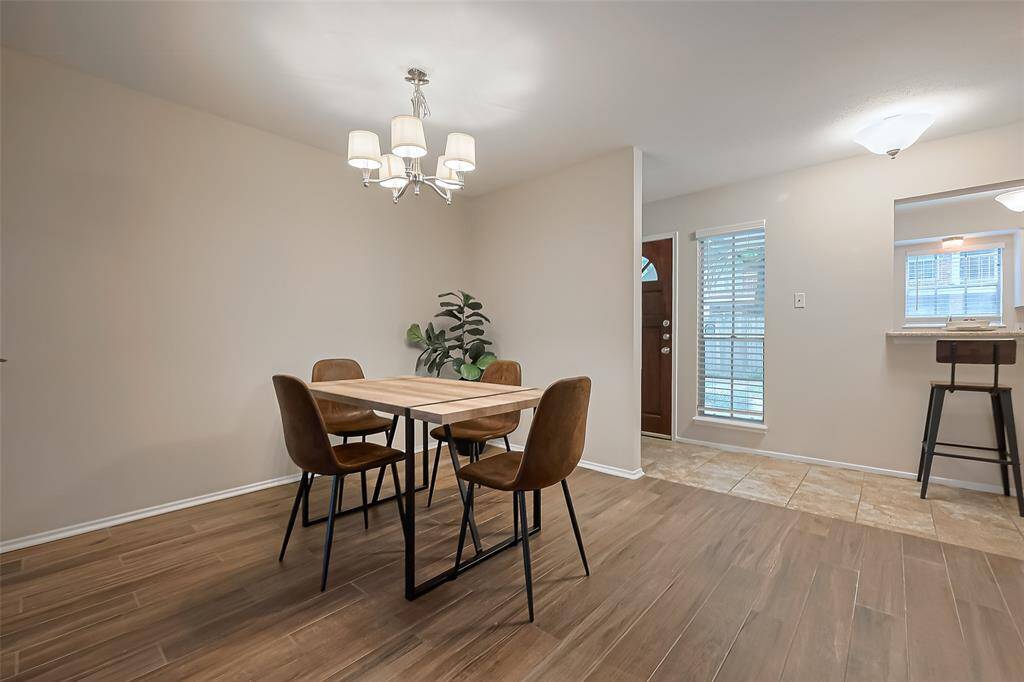 The open-concept dining area is perfectly positioned across from the cozy breakfast bar, offering a seamless flow for everyday meals or easy entertaining.