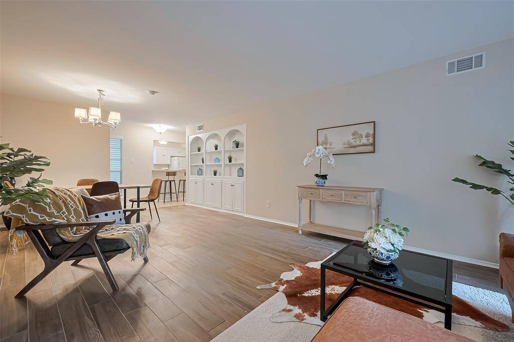 This spacious open concept living area is filled with natural light, offering a warm and inviting space that’s perfect for both relaxing and entertaining.