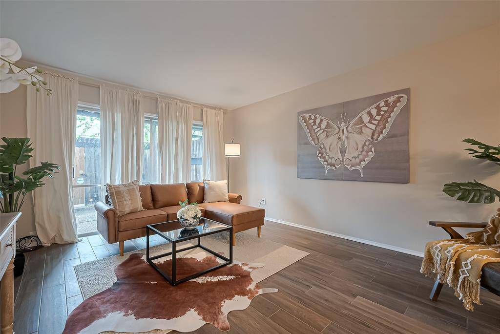 Large sliding glass doors not only flood the space with beautiful natural light but also provide easy access to the back patio and yard—ideal for indoor-outdoor living and entertaining.