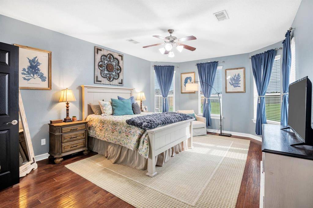 Beautiful windows in the primary bedroom overlook the back yard.