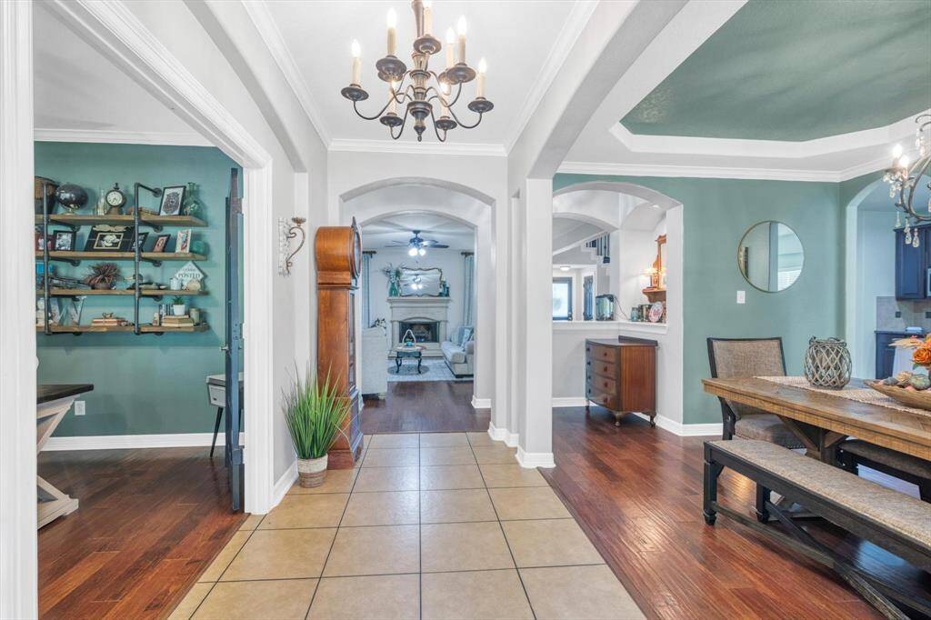 From left to right is the office, hallway leading to the additional guest bedroom and bathroom, living room ahead with access to the primary bedroom and kitchen, and dining room to the right with another door to the kitchen.