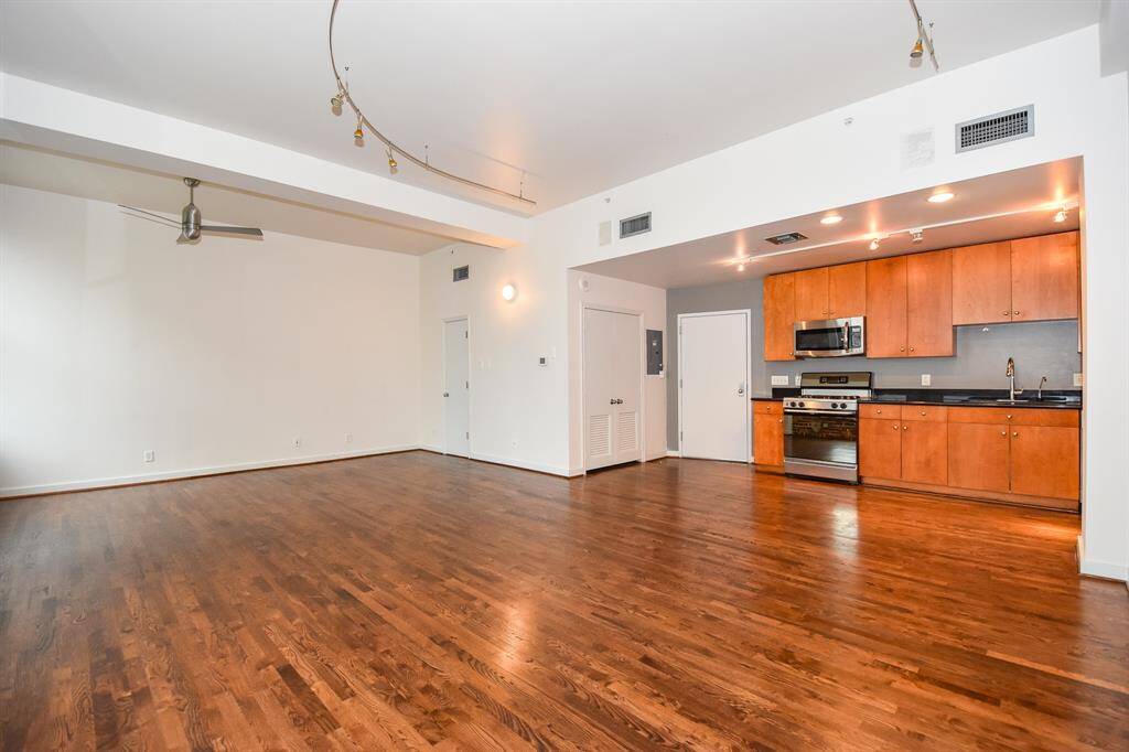 Spacious open-concept kitchen and living area with seamless flow—perfect for entertaining. The kitchen features sleek finishes, ample storage, and a breakfast bar, all overlooking the bright, inviting living space with downtown views.