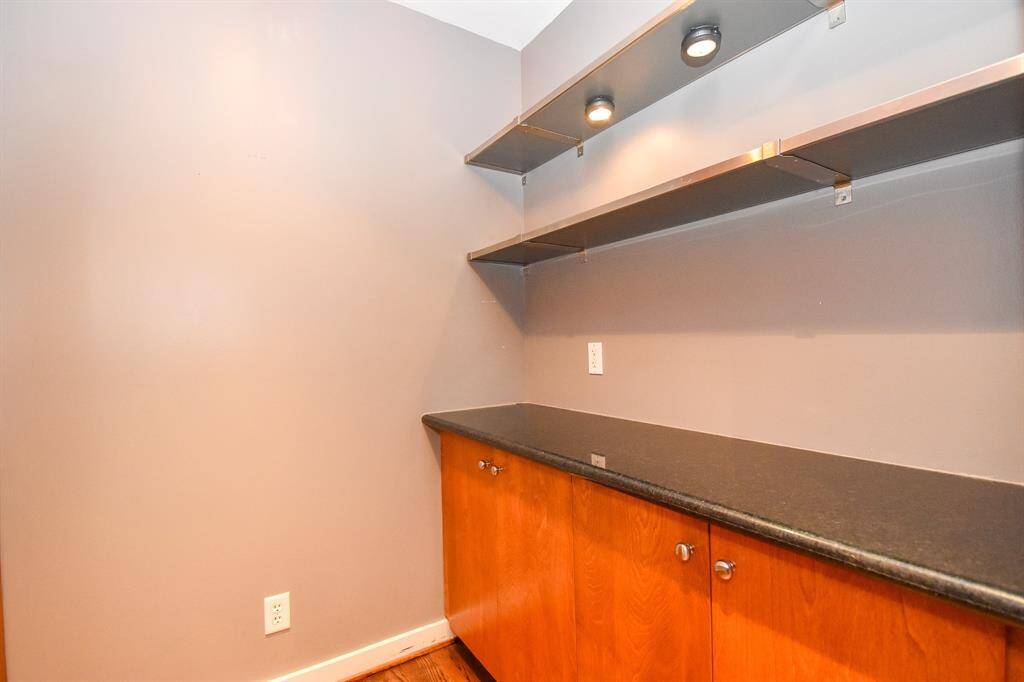 Stylish dry bar area with a sleek countertop, ideal for entertaining.