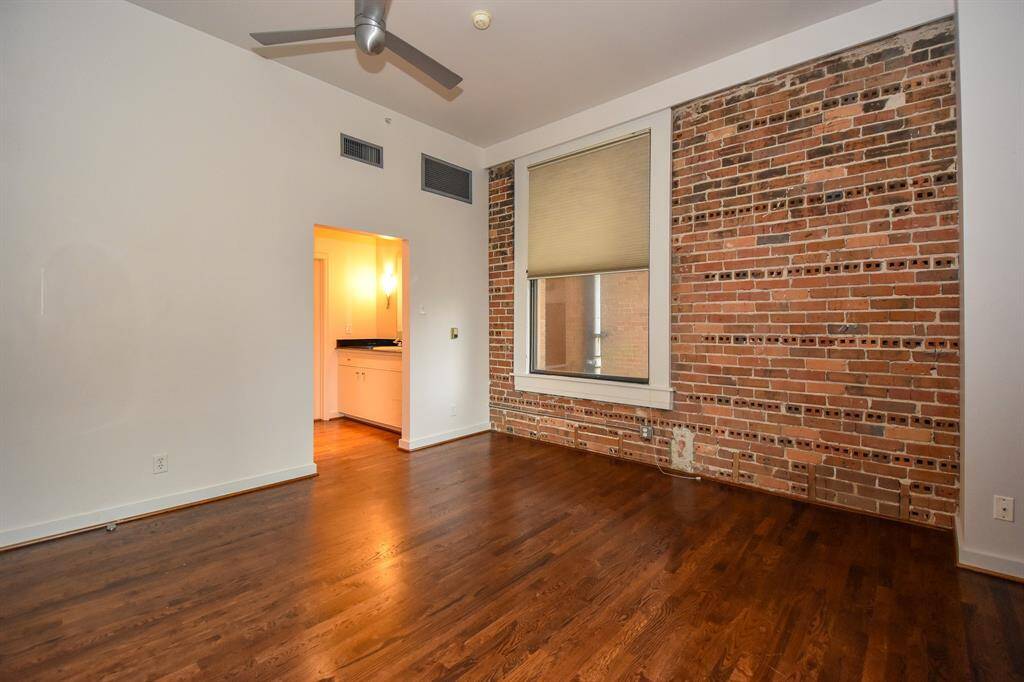 Spacious primary bedroom featuring large windows that fill the room with natural light. The room includes a well-sized closet, offering ample storage
