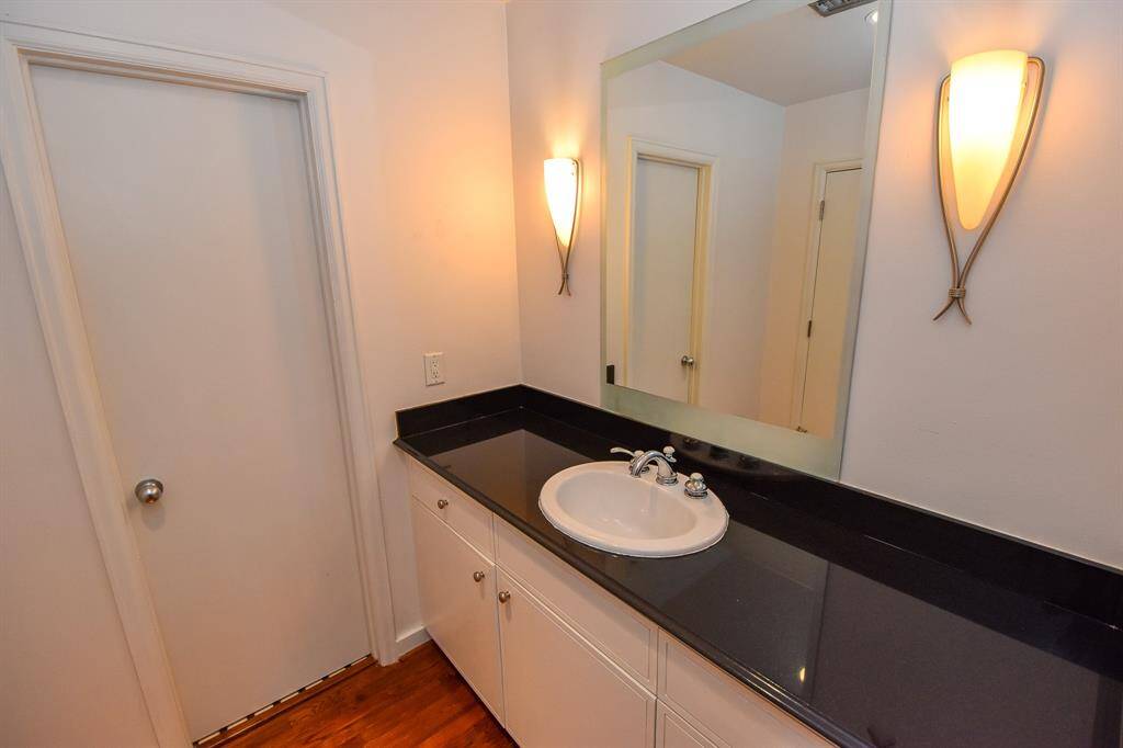 primary bathroom featuring a stylish sink and mirror with modern finishes. The clean design and ample counter space create a functional and elegant space.