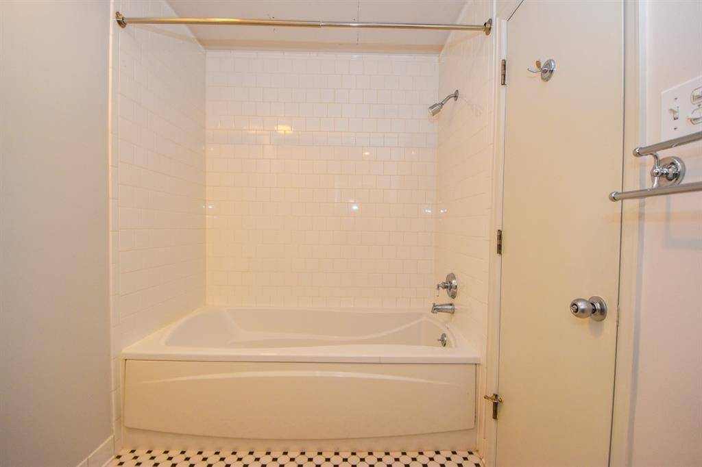 The primary bathroom soaking tub alongside a separate shower.