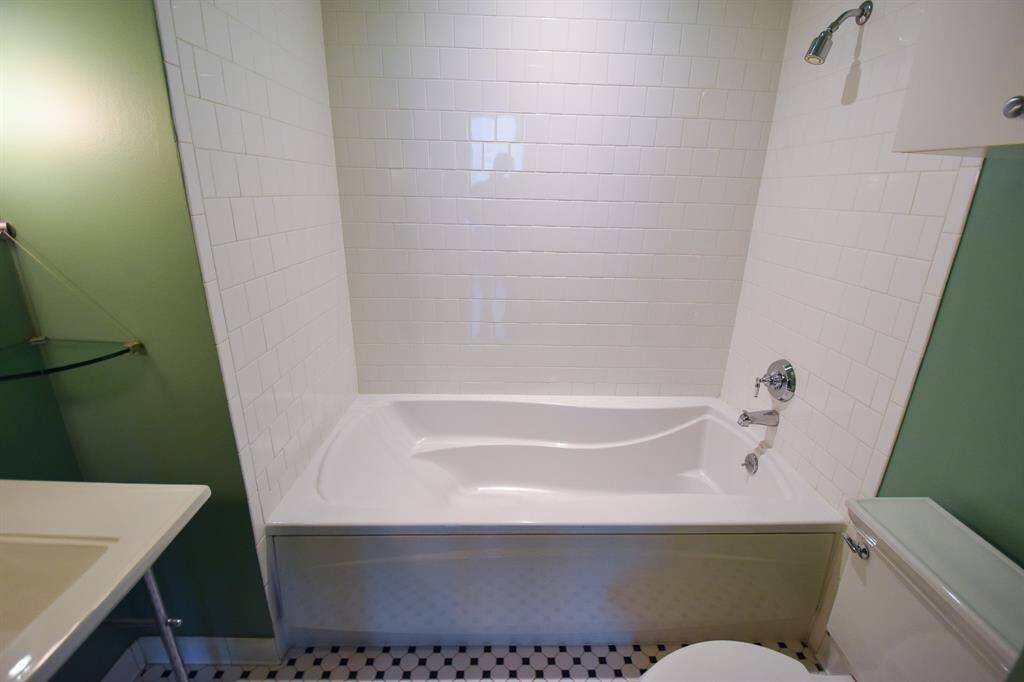 Another angle of the second bathroom, showcasing the relaxing soaking tub alongside a separate shower.