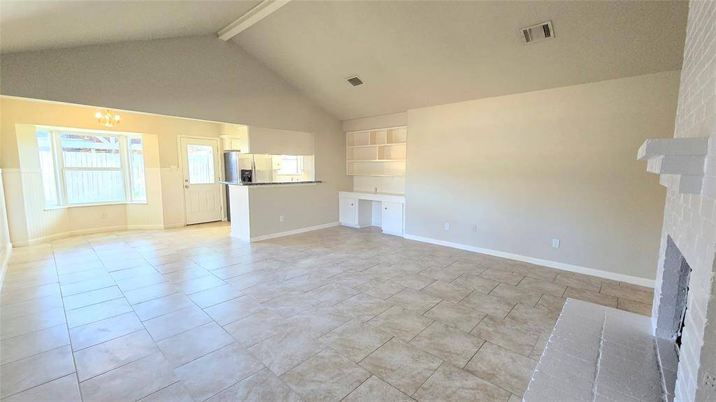 In the den, the built-in desk and bookshelf area offer the perfect spot to organize your mail or create a cozy workspace. It’s both functional and stylish, adding charm to this welcoming room.