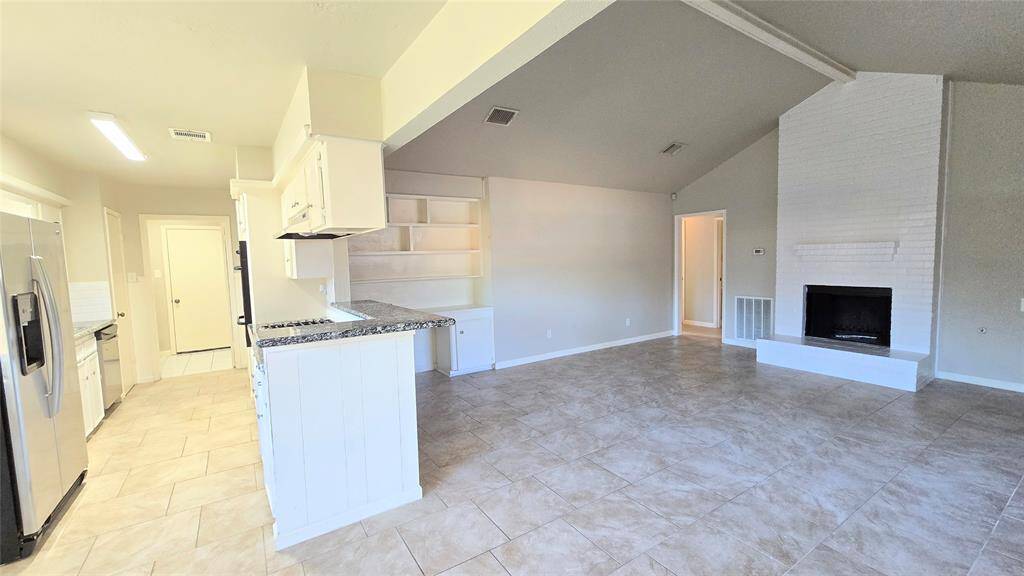 The den flows effortlessly into the updated kitchen, making it easy to stay connected with family while cooking. Whether you're hosting or relaxing, this open space is perfect for making memories.