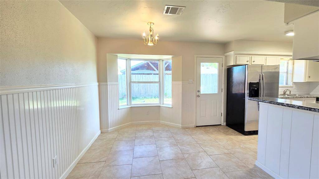 Imagine cooking a delicious meal in the kitchen and serving it hot right onto the plate in the breakfast area, where natural light pours in through the bay window. The serene backyard view makes every meal feel extra special.