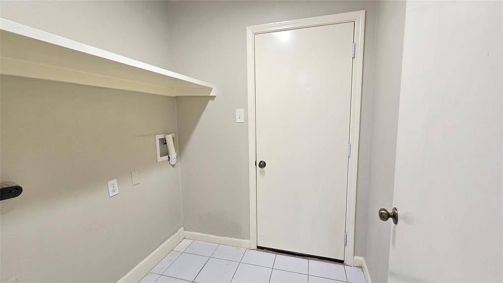This cozy laundry area is conveniently located next to the kitchen, making chores a breeze. The door leads straight to the garage, adding even more ease to your daily routine.