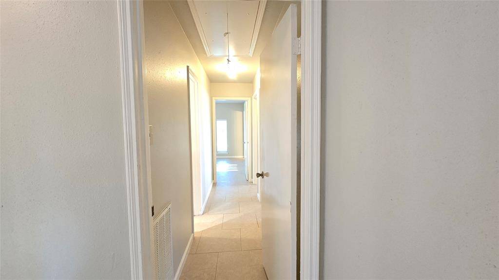 The bedroom corridor has its own door for added privacy when hosting guests, ensuring a quiet, separate space just steps away from the main living areas.
