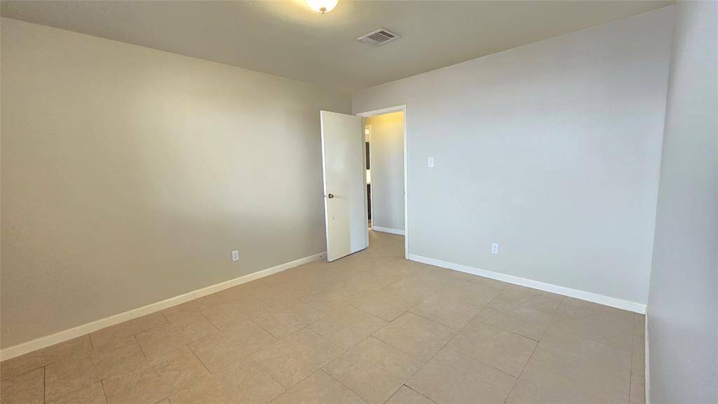 Third bedroom is bright and airy with a large picture window, offering beautiful views and a spacious walk-in closet, perfect for all your storage needs.