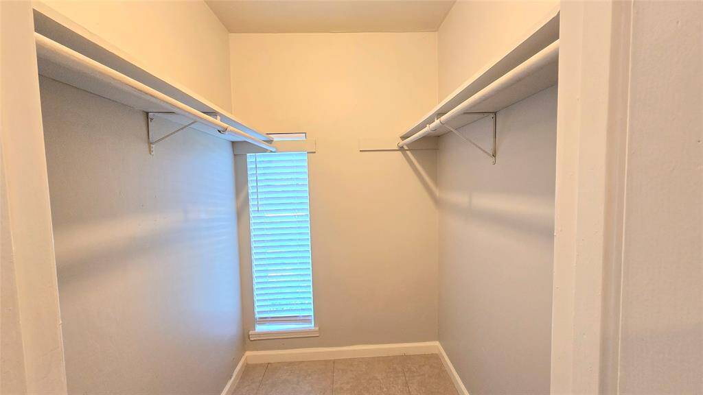 The walk-in closet has its own window overlooking the backyard—filling the space with light and a touch of charm.