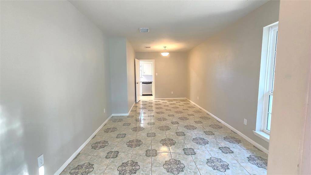 To the right of the entry, this spacious formal living & dining room offers the perfect blend of elegance and comfort. It’s also great for an office space!