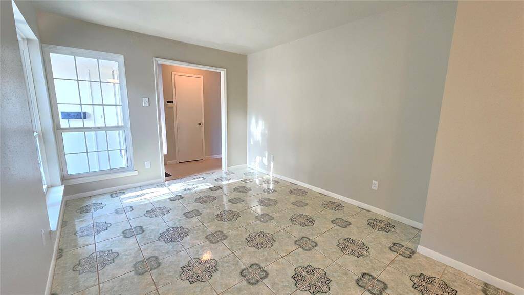 Imagine working or unwinding in this bright formal living & dining room, where natural light pours in and the sleek tile flooring sets a stylish tone. Perfect for an office or a peaceful retreat.
