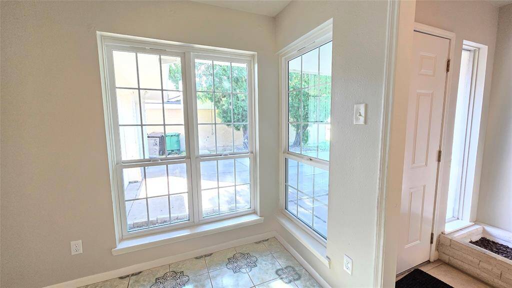 The formal living and dinning room is bathed in natural light, thanks to the large double-pane windows that brighten the entire room.