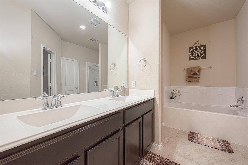 Double vanity, wall to wall mirror and ample lighting.