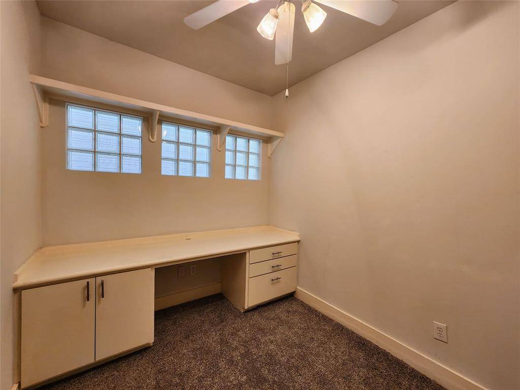 2nd bedroom downstairs with build in desk/cabinet/drawers can be used as an home office
