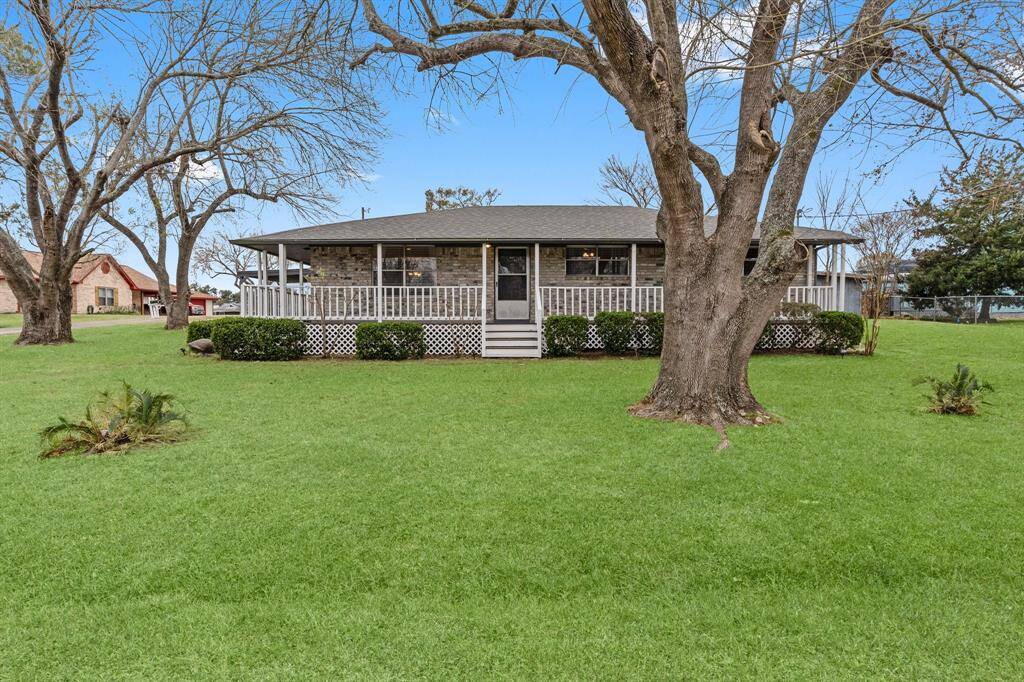 Aerial photo shows a lakeside community. The neighborhood is nestled near Lake Livingston, offering scenic views and a relaxed atmosphere ideal for a tranquil lifestyle.