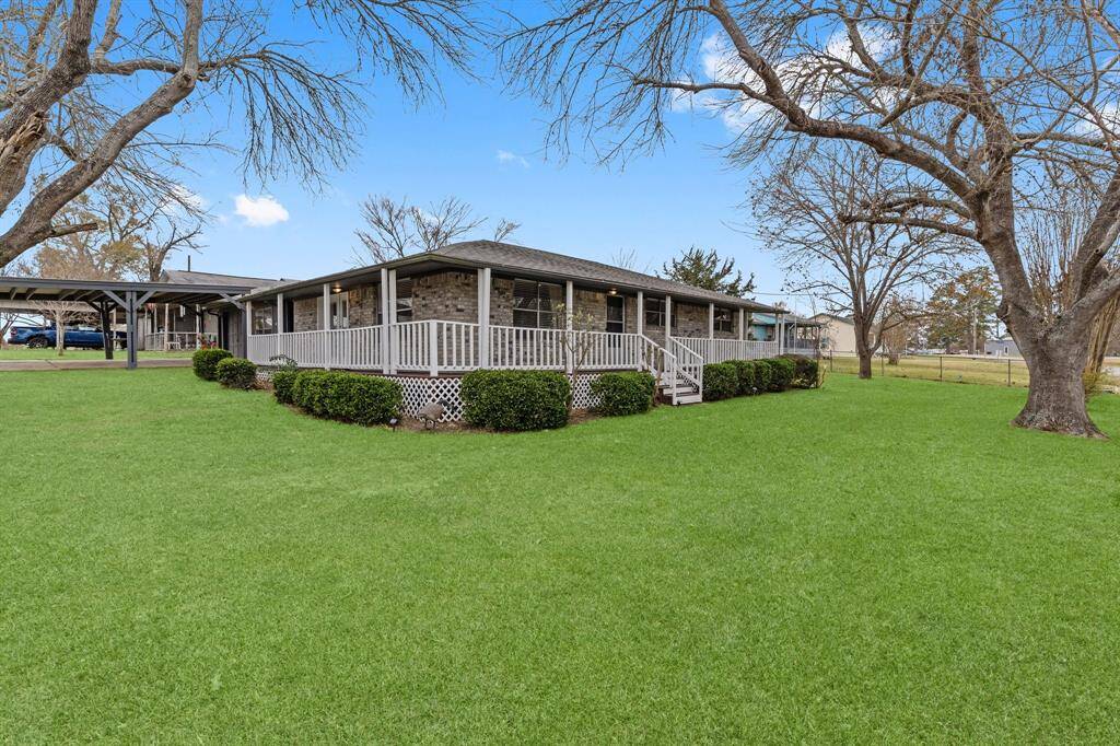 This charming home features a spacious front porch and a well-maintained lawn, offering a cozy and inviting curb appeal.