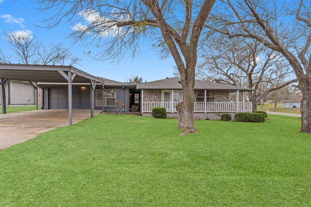 Charming single-story home with a spacious carport.