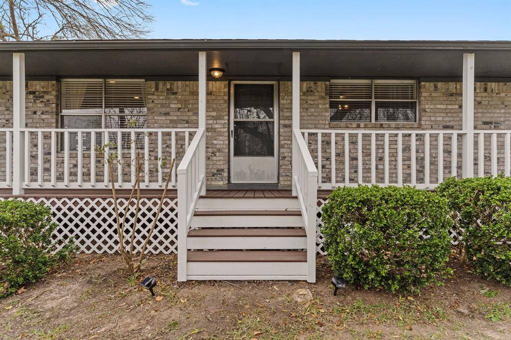 Charming home with a welcoming front porch offering a cozy and inviting exterior.