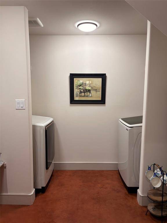 The washer and dryer are located in the backside of the pantry. To the right is a whole home water filtration system and the butlers pantry.