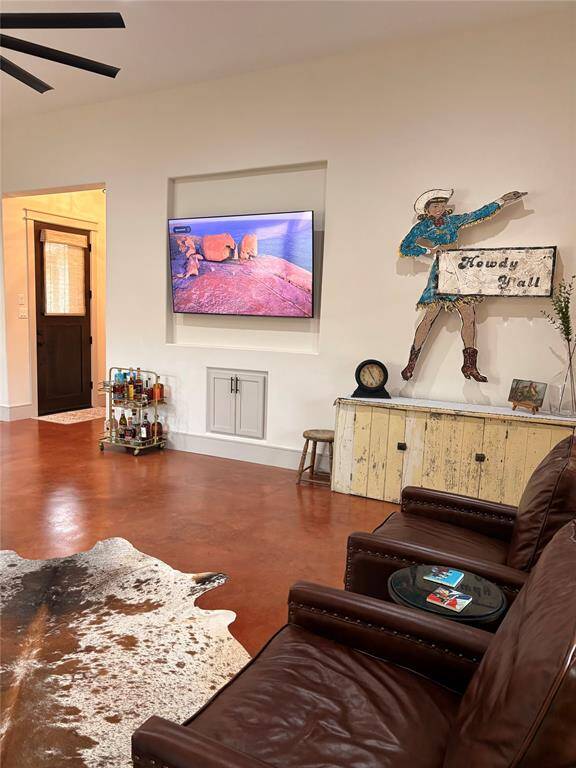 This pretty family room is large and can accommodate lots of seating for family and friends. Lots of custom touches are seen throughout the house. Tall ceilings, TV niche, custom cabinets, tall baseboards, and pretty window ledges and door trim.