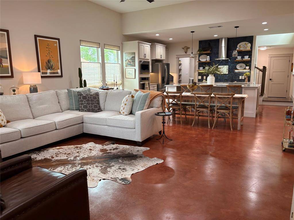 In this picture you can see the base of the stairwell and the door that leads to the oversized garage. The garage is just as pretty as the rest of the house with the same neutral paint, pretty window seals, and an epoxy floor.